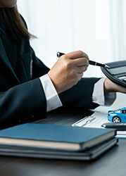 Car dealer provides advice on loans, insurance details, car rental information, delivers car with keys after the rental contract is signed. successful car loan contract buying or selling new vehicle.